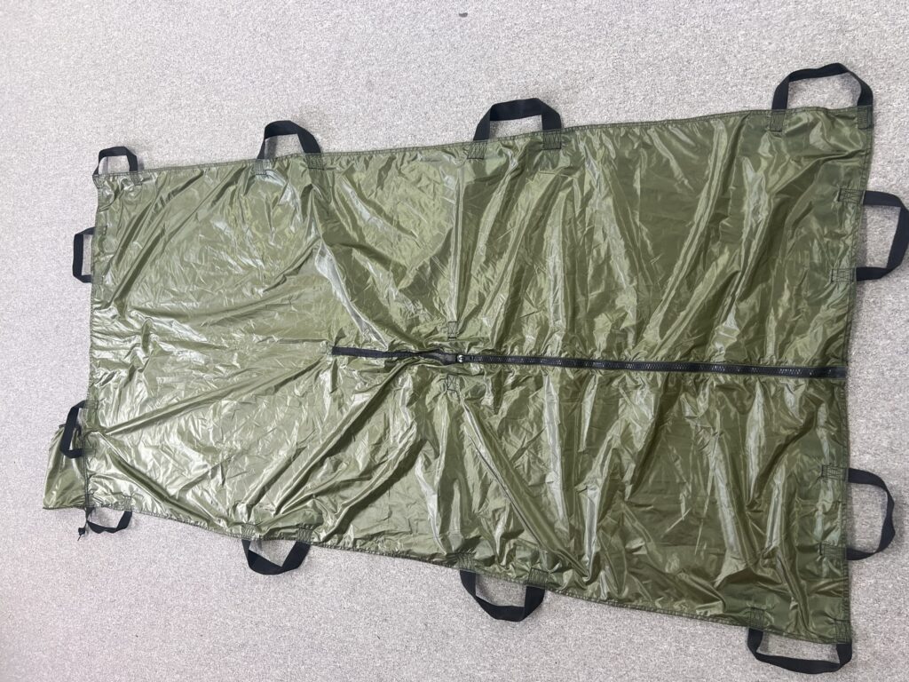 Olive-green Soft Gurney laid flat with central zipper and webbing handles along the sides