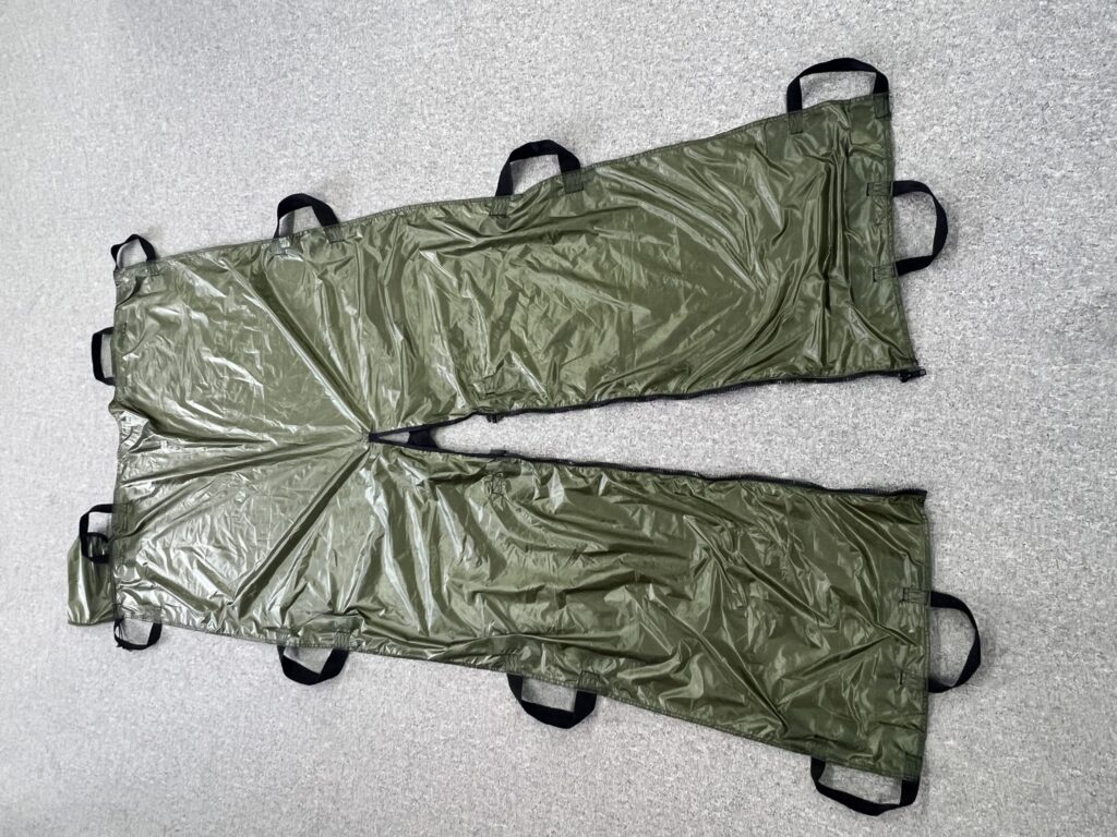 Soft Gurney with the central zipper open, spread wide on the floor
