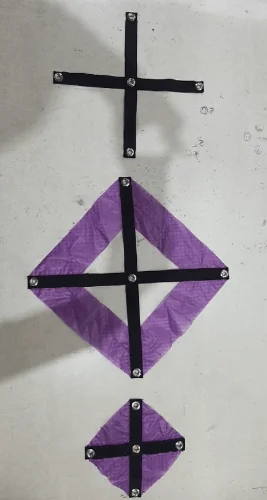 Sliders in three versions: a webbing cross with grommets and two sliders made of purple fabric